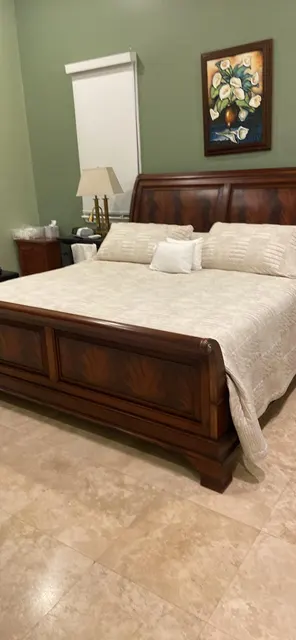 Bedroom cleaned with the bed made and linens smoothed