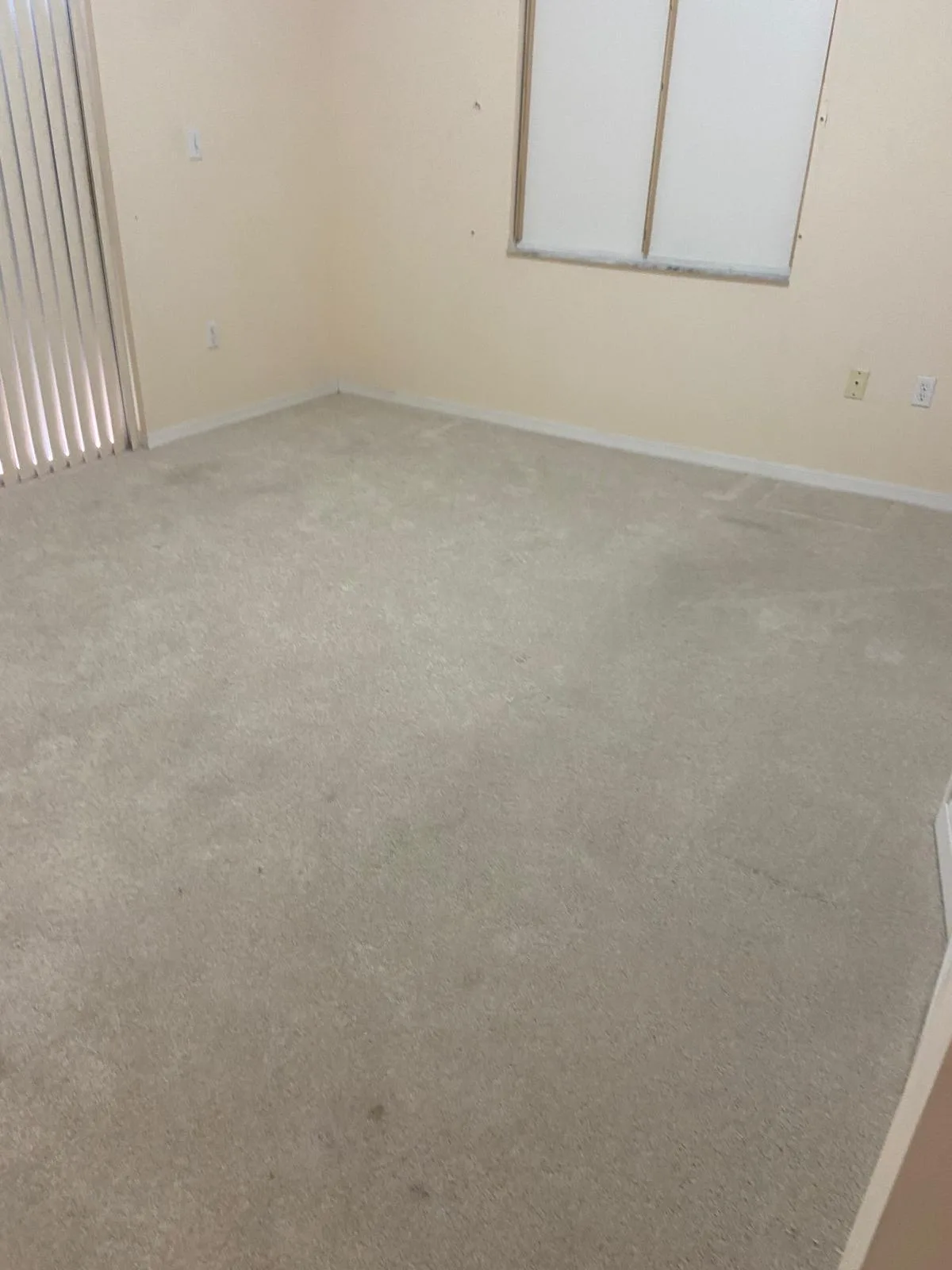 Empty carpeted room vacuumed and ready for move-in